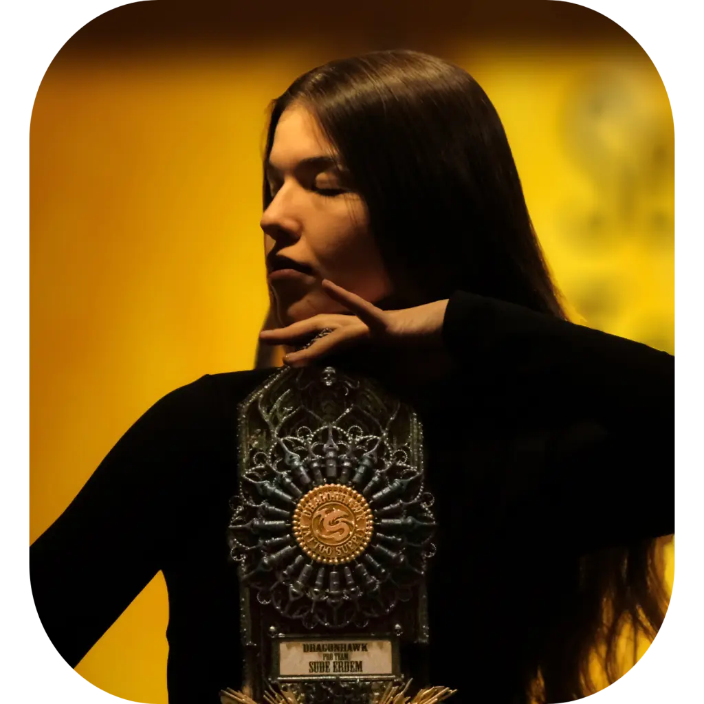Award-winning tattoo artist Sude Erdem holding an international tattoo award in Los Angeles